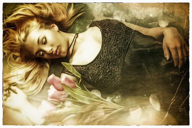 仰向けで眠る黒いドレスを着た美しい女性と横にピンク色の花